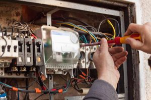 Electrician tinkering with an electrical panel