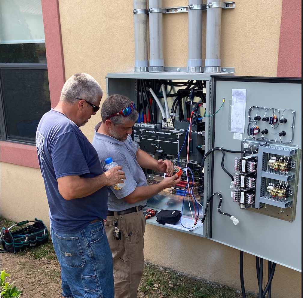 Electrician tinkering with an electrical panel