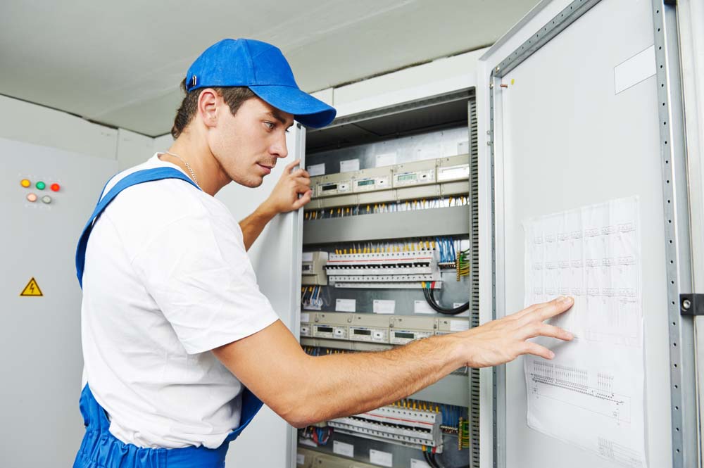 Technician inspecting an electrical panel