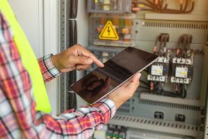 Technician inspecting electrical panels