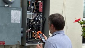 Technician tinkering with an electrical panel Deltona, FL