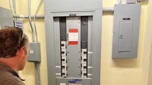 electrician inspecting electrical panel Merritt Island, FL